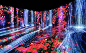 An art gallery displaying a digitally-animated scene of colorful flowers and waterfalls along the walls and floor.